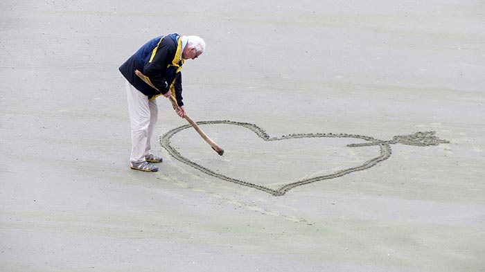 Love-on-sand-by-and-old-man-stock
