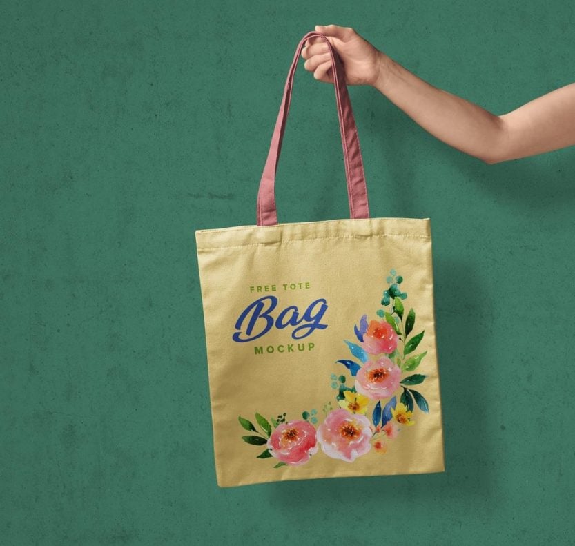 Free Hand Holding Tote Shopping Bag Mockup PSD - Designbolts