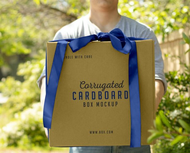 Download Free Hand Holding Corrugated Cardboard Box Mockup PSD ...