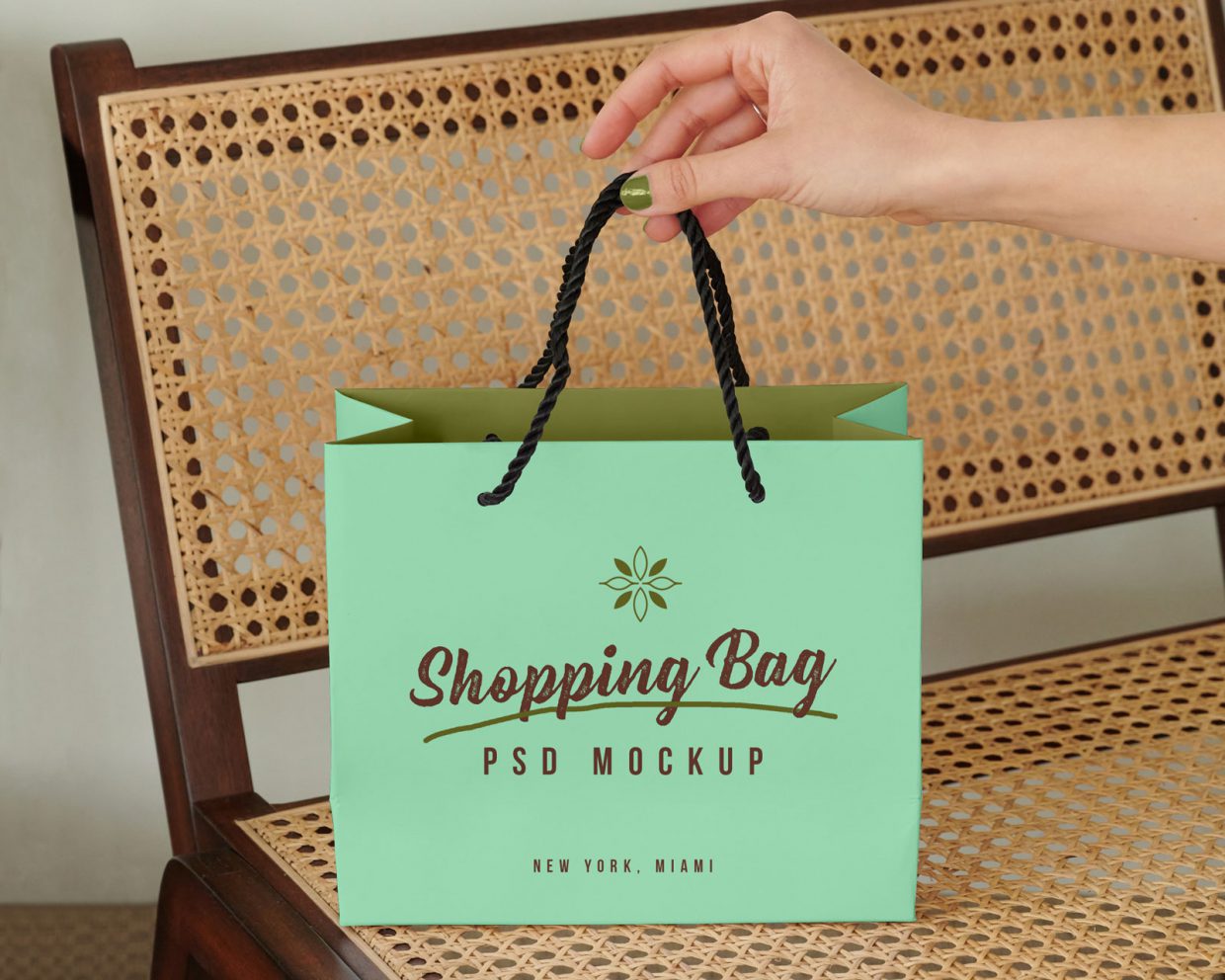 Free Hand Holding Shopping Bag Mockup PSD - Designbolts